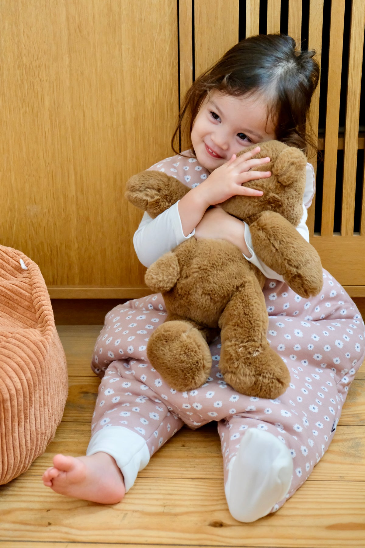enfant fille portant sa peluche en gigoteuse à pieds guimauve